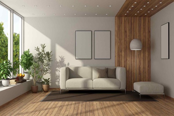 Phòng khách với sofa màu xám, các đèn trang trí và bức tranh tường tối giản, tạo điểm nhấn mà không làm mất đi vẻ đơn giản của không gian