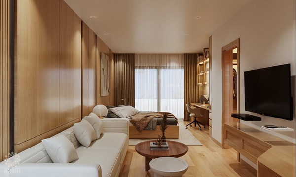 Phòng ngủ kết hợp không gian giải trí với bộ ghế sofa và kệ tivi được bố trí gọn gàng